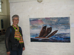Aartje beside a quilt depicting a Friesland fishing vessel at the fiber art show in Deventer